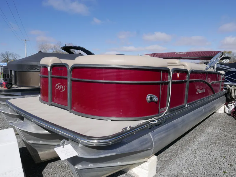 Slide: The Image of 2015 Manitou Oasis pontoon boat with red exterior and beige seating. - 6