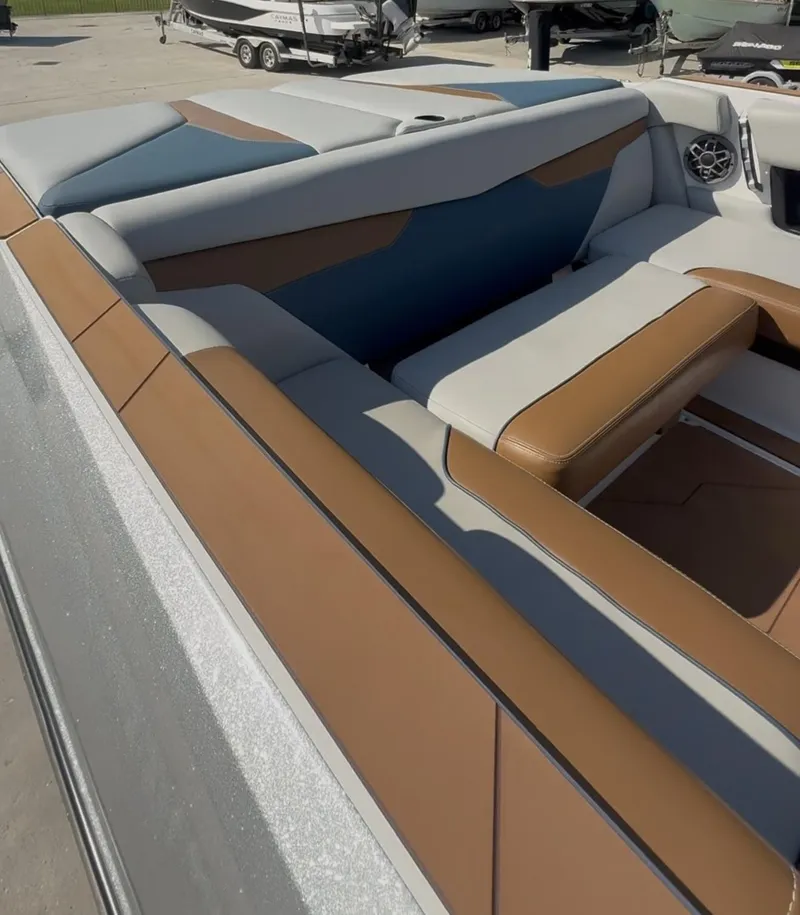 Slide: The Image of 2021 Axis A24 boat interior with brown and gray seating, featuring a sleek design. - 14