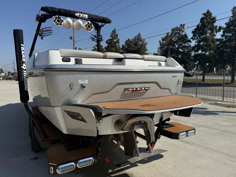 Slide: The Image of 2021 Axis A24 boat with wakeboard tower and swim platform, parked outdoors. - 5