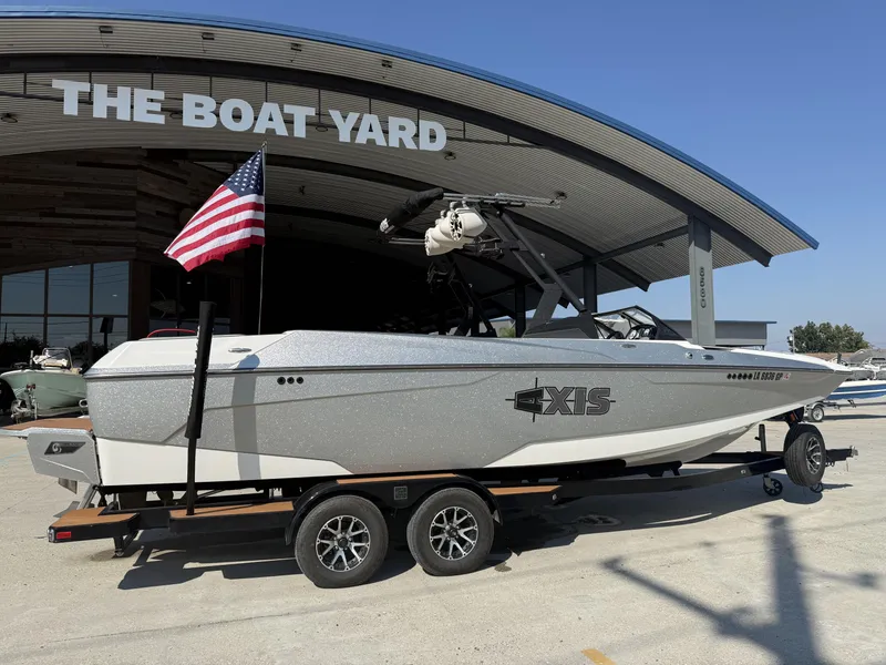Slide: The Image of 2021 Axis A24 boat on trailer at The Boat Yard, American flag displayed. - 7