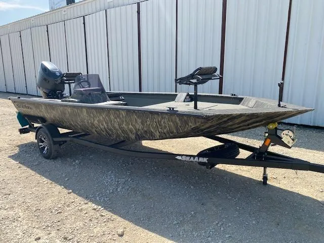 Slide: The Image of 2025 SeaArk Shadow 18 boat on trailer, parked outdoors. - 1