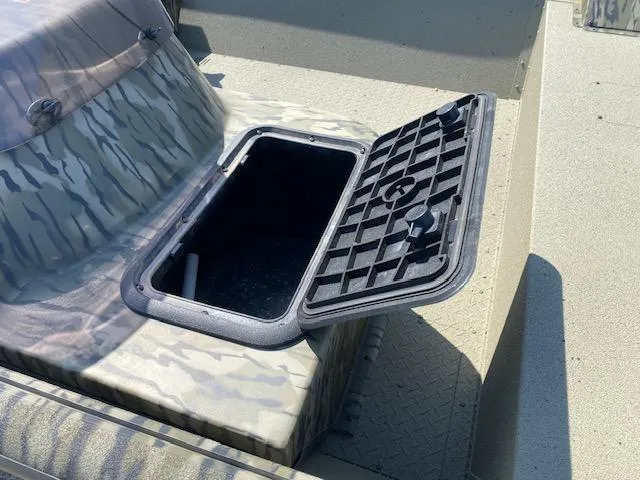 Slide: The Image of Open storage compartment on 2025 SeaArk Shadow 18 boat with camouflage design. - 11