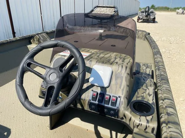 Slide: The Image of 2025 SeaArk Shadow 18 boat dashboard with steering wheel and control panel. - 7