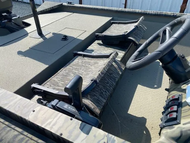 Slide: The Image of 2025 SeaArk Shadow 18 interior with camo seating and steering wheel. - 8