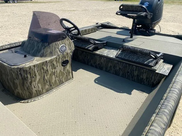 Slide: The Image of 2025 SeaArk Shadow 18 boat interior with camouflage design and steering console. - 9