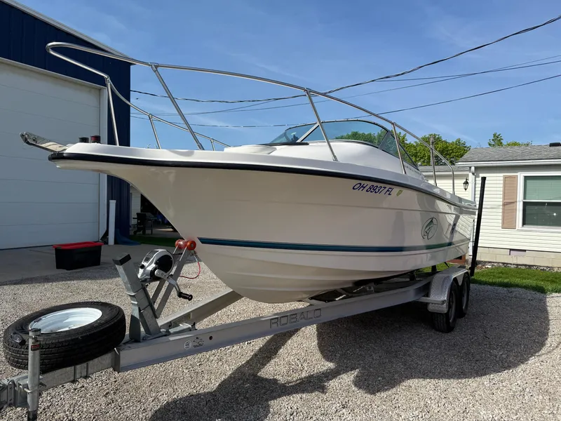 Slide: The Image of 1998 Bayliner 2052 Trophy Walkaround boat on trailer, parked outdoors. - 13