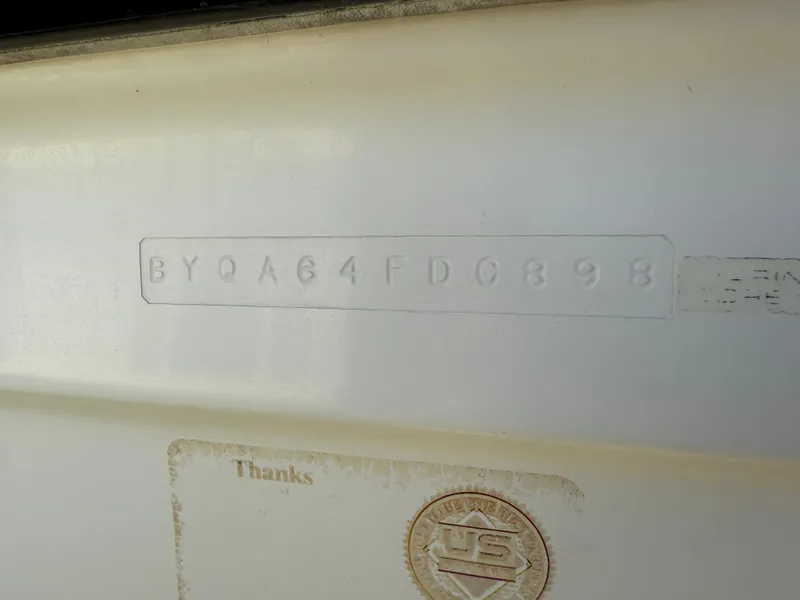 Slide: The Image of 1998 Bayliner 2052 Trophy Walkaround hull identification number on white surface. - 16