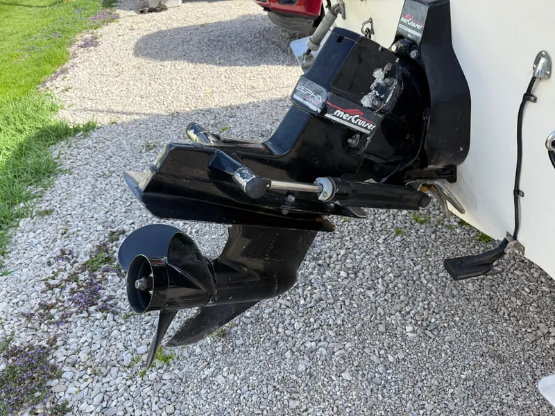 Slide: The Image of 1998 Bayliner 2052 Trophy Walkaround boat with MerCruiser outboard motor on gravel. - 18