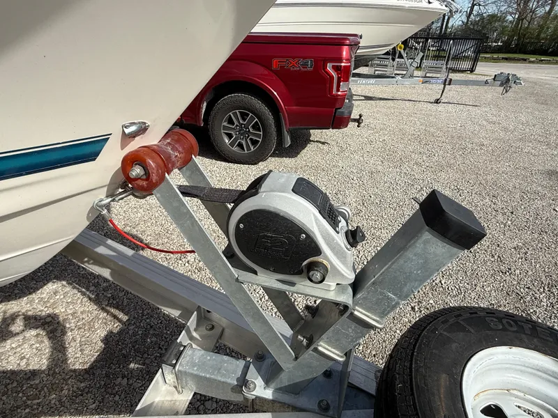 Slide: The Image of 1998 Bayliner 2052 Trophy Walkaround on trailer, with red truck in background. - 19