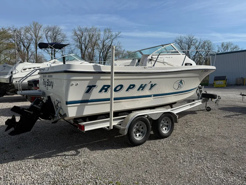 Slide: The Image of 1998 Bayliner 2052 Trophy Walkaround boat on trailer, parked outdoors. - 2