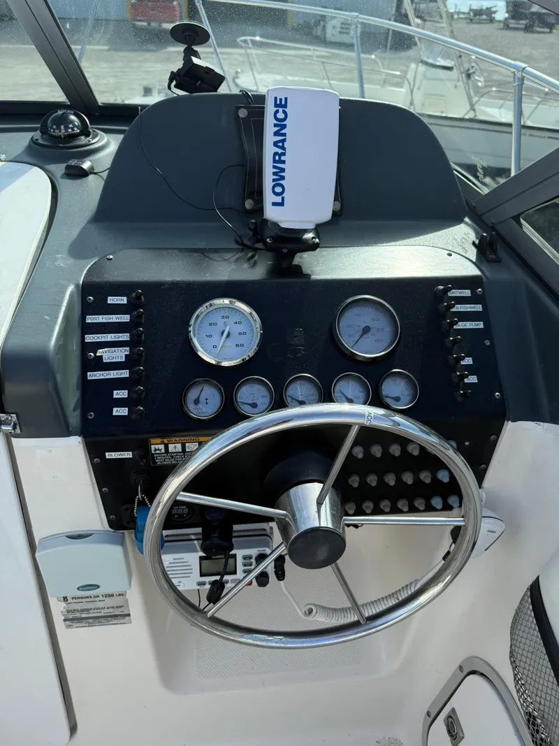 Slide: The Image of 1998 Bayliner 2052 Trophy Walkaround dashboard with Lowrance navigation system and gauges. - 21