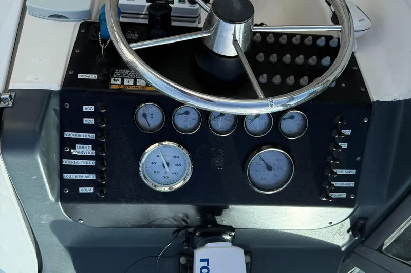 Slide: The Image of Dashboard of a 1998 Bayliner 2052 Trophy Walkaround boat with gauges and steering wheel. - 5