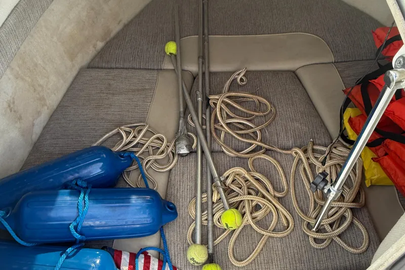 Slide: The Image of Interior of 1998 Bayliner 2052 Trophy Walkaround with ropes, fenders, and safety equipment. - 6