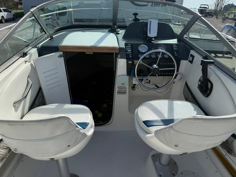 Slide: The Image of 1998 Bayliner 2052 Trophy Walkaround boat interior with steering wheel and seating. - 7