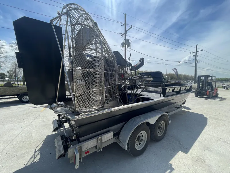 Slide: The Image of 2008 Custom Alumitech 20 Airboat on trailer under clear sky. - 3