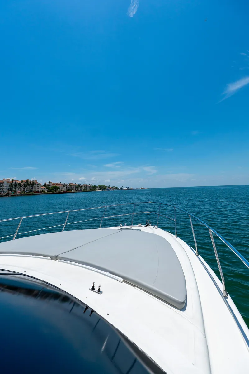 Slide: The Image of Azimut 43 Fly yacht cruising on open water under clear blue sky. - 15