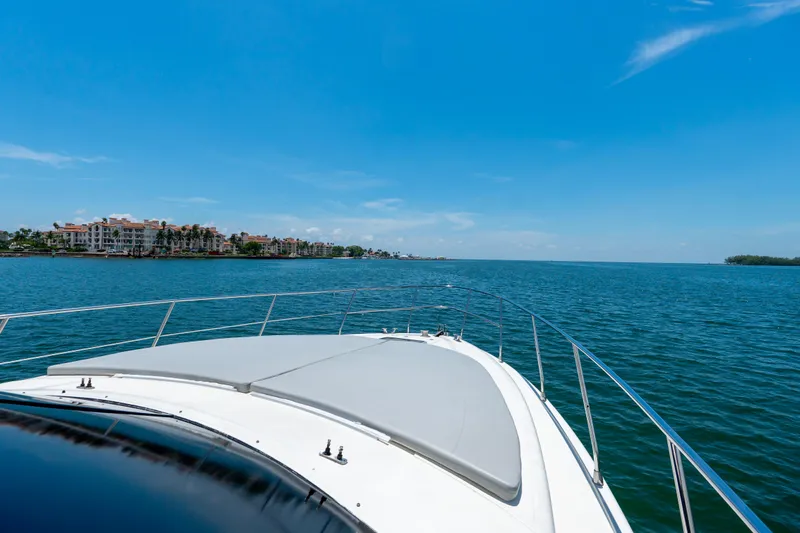 Slide: The Image of Bow view of 1998 Azimut 43 Fly yacht cruising on a sunny day. - 16