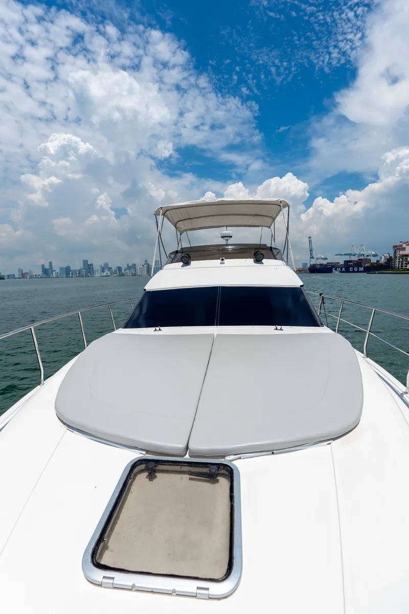 Slide: The Image of Azimut 43 Fly yacht, 1998 model, cruising on open water under a partly cloudy sky. - 19