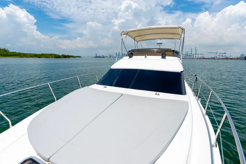 Slide: The Image of Azimut 43 Fly yacht cruising on open water under a clear blue sky. - 20