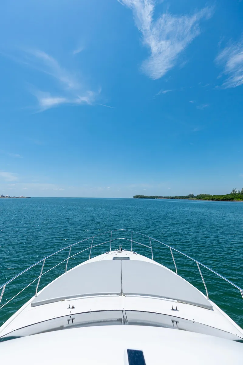 Slide: The Image of Azimut 43 Fly yacht cruising on a clear blue sea under a sunny sky. - 26
