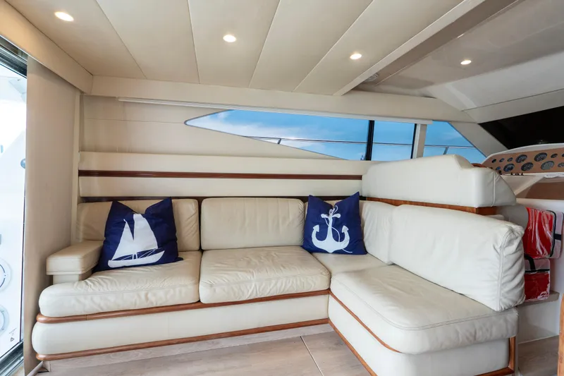 Slide: The Image of Luxurious interior of 1998 Azimut 43 Fly yacht with white leather seating and nautical pillows. - 32