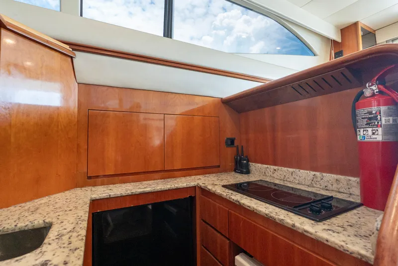 Slide: The Image of Azimut 43 Fly 1998 yacht kitchen with wooden cabinetry and granite countertops. - 35