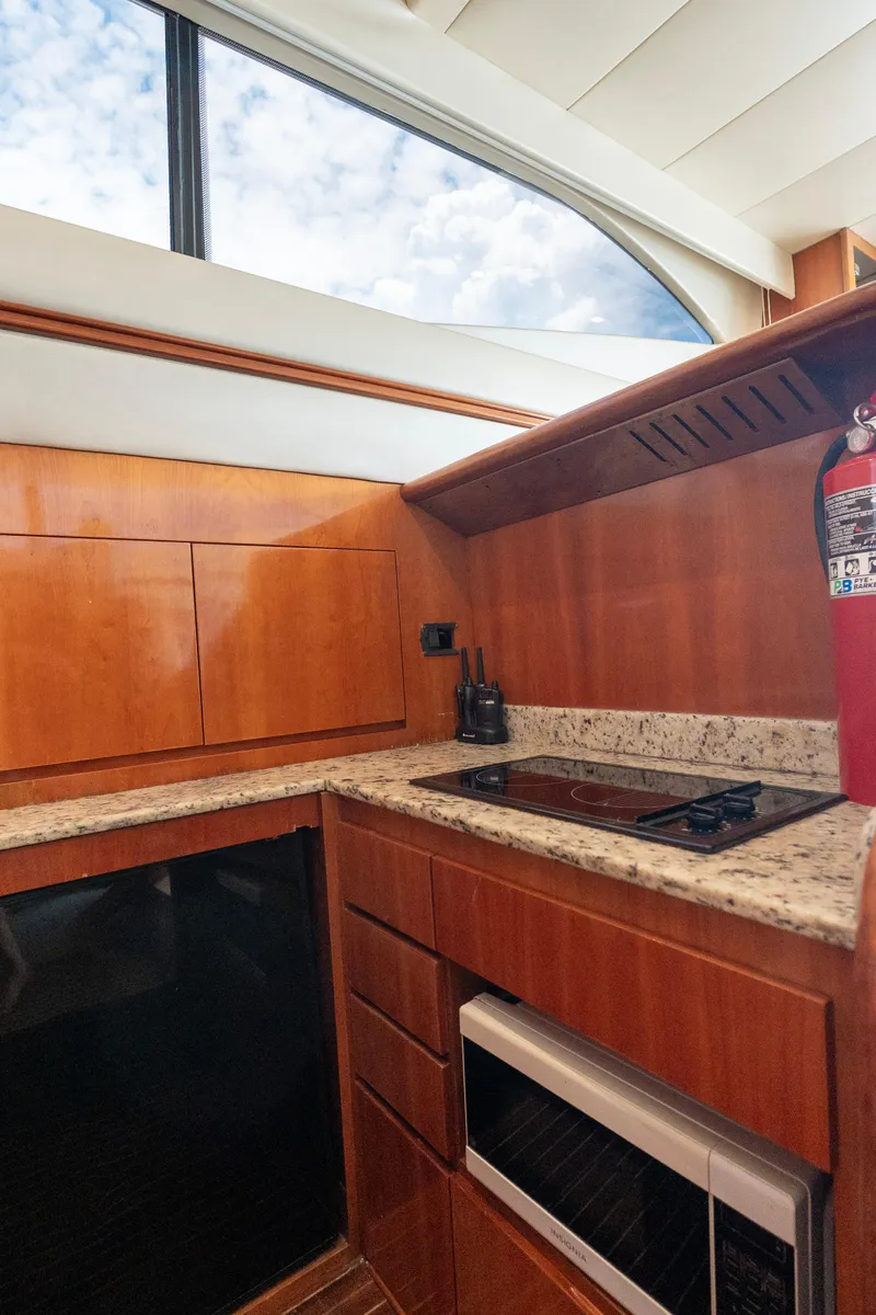 Slide: The Image of Luxurious kitchen interior of 1998 Azimut 43 Fly yacht with wooden cabinetry and modern appliances. - 36