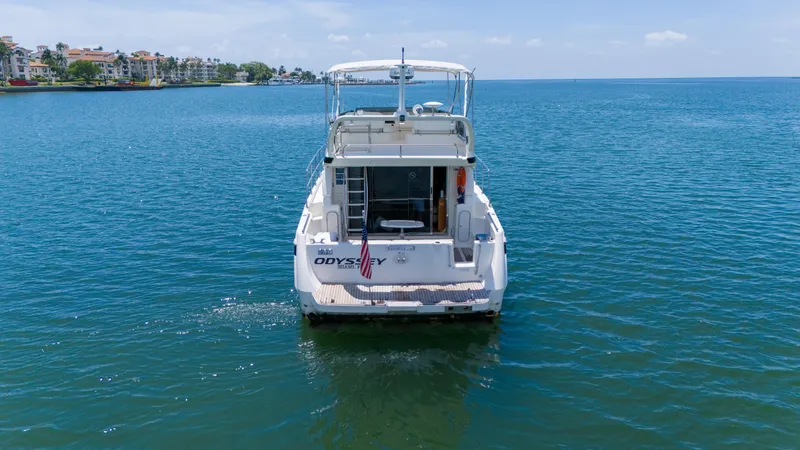 Slide: The Image of Azimut 43 Fly 1998 yacht on calm blue water, rear view, clear sky. - 4