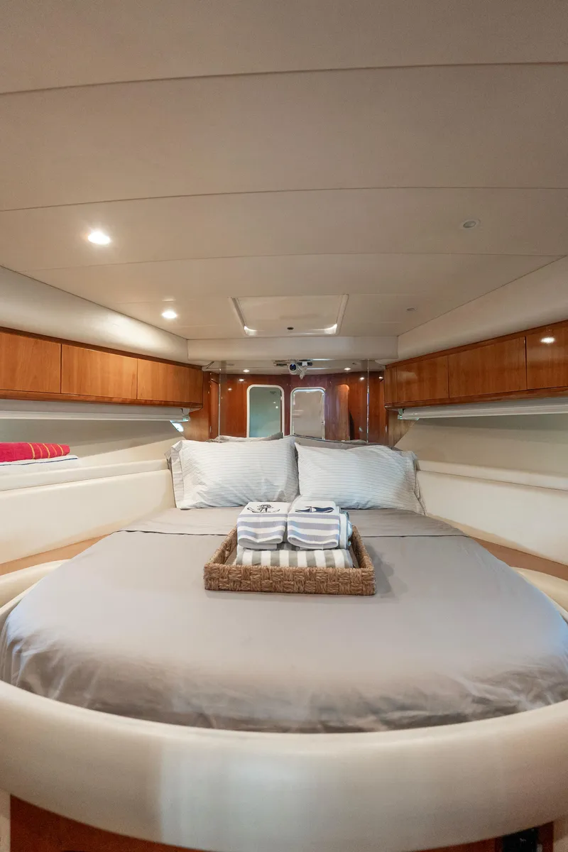 Slide: The Image of Luxurious cabin interior of 1998 Azimut 43 Fly yacht with cozy bed and elegant wood finish. - 41
