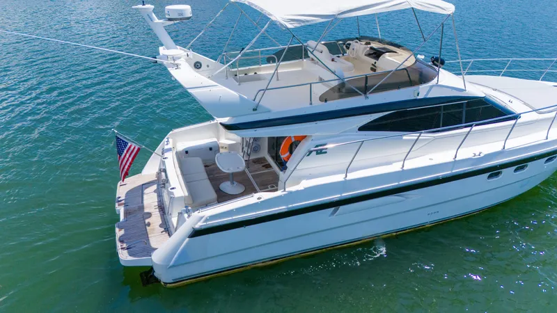 Slide: The Image of Azimut 43 Fly 1998 yacht on water, featuring spacious deck and flybridge. - 5