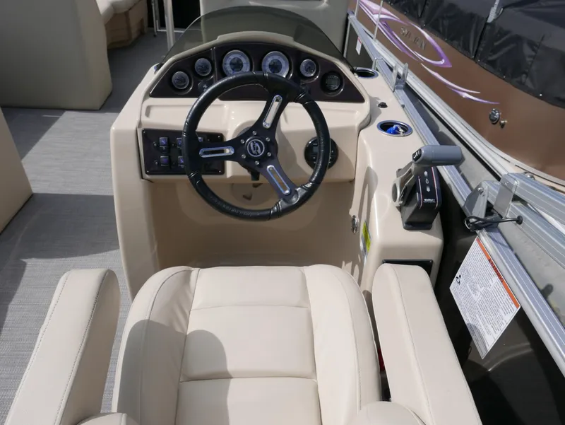 Slide: The Image of 2017 Sylvan 8522 Mirage Cruise boat dashboard with steering wheel and controls. - 13