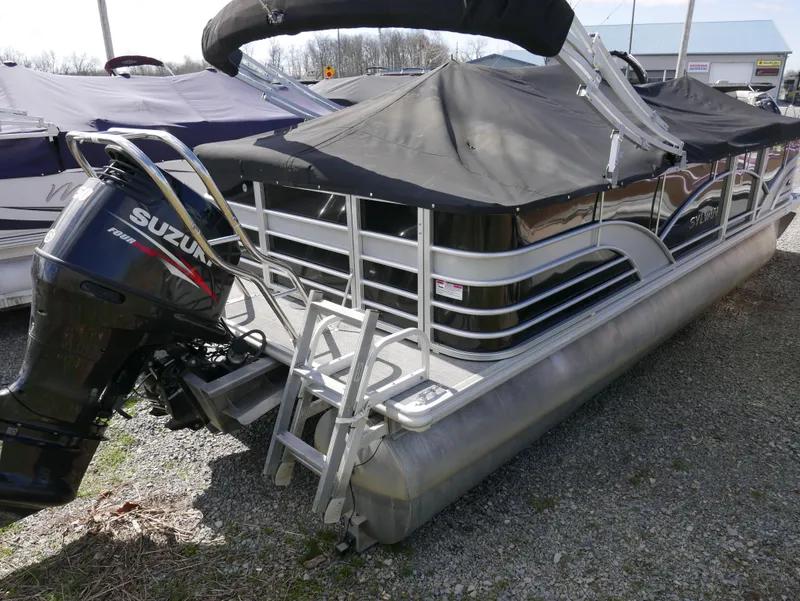 Slide: The Image of 2017 Sylvan 8522 Mirage Cruise pontoon boat with Suzuki outboard motor, covered and docked. - 5