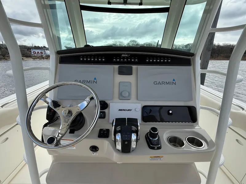 Slide: The Image of 2018 Boston Whaler 330 Outrage helm with Garmin displays and Mercury controls. - 10