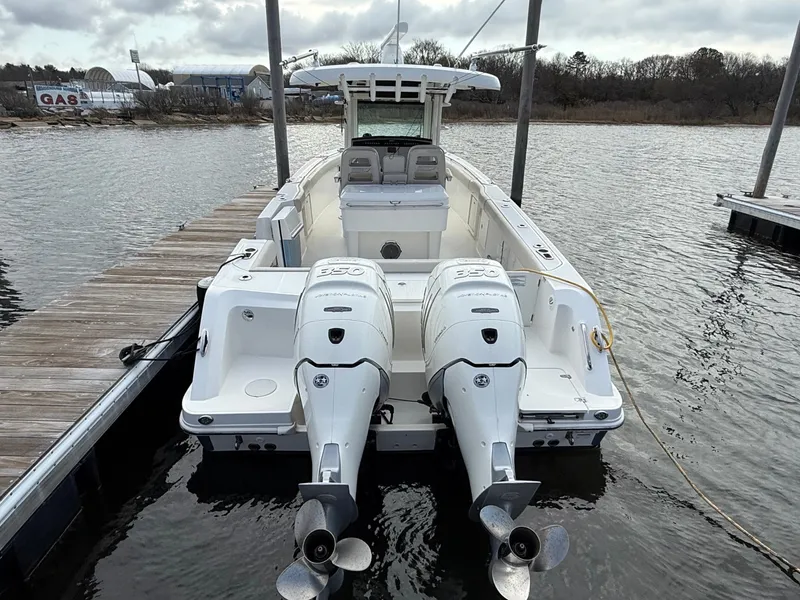 Slide: The Image of 2018 Boston Whaler 330 Outrage boat docked with twin engines, rear view. - 2