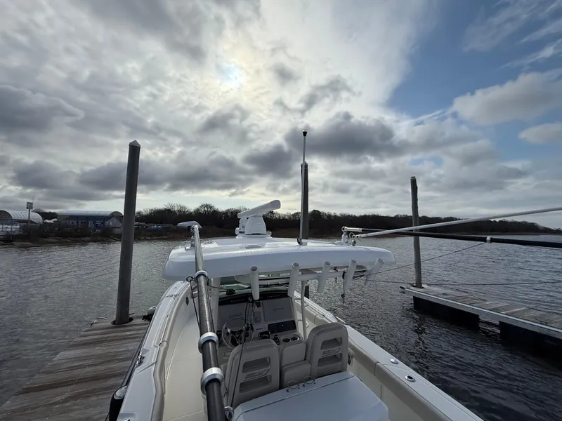 Slide: The Image of 2018 Boston Whaler 330 Outrage docked under cloudy sky. - 6
