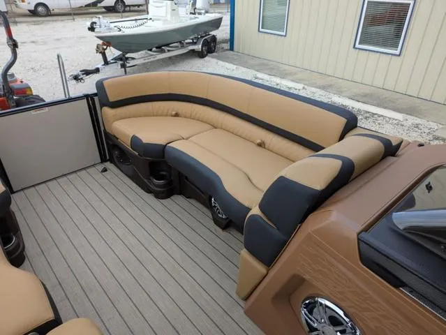 Slide: The Image of 2025 Avalon Catalina Quad Lounger 23 FT with tan and black seating on a boat deck. - 10