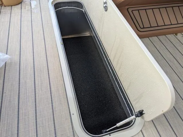 Slide: The Image of Storage compartment on 2025 Avalon Catalina Quad Lounger 23 FT boat, open on deck. - 11