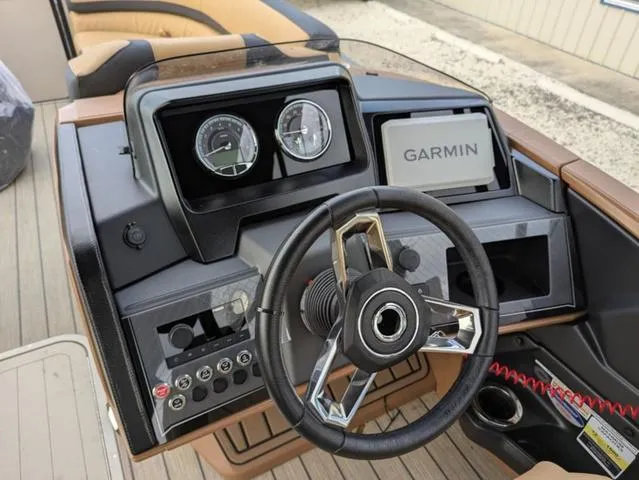 Slide: The Image of Steering console of 2025 Avalon Catalina Quad Lounger 23 FT with Garmin navigation system. - 13
