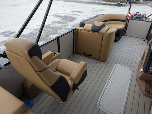 Slide: The Image of 2025 Avalon Catalina Quad Lounger 23 FT interior with tan seating and spacious deck layout. - 17