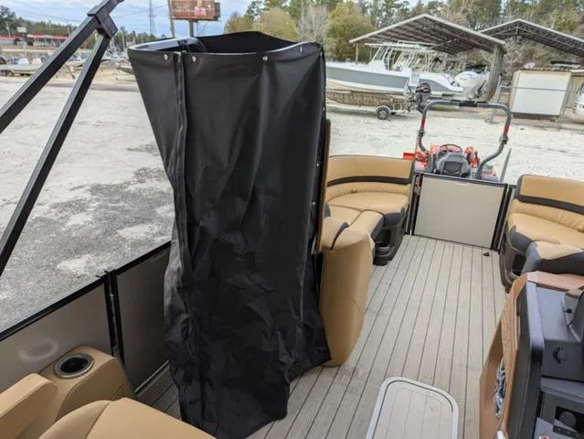 Slide: The Image of 2025 Avalon Catalina Quad Lounger 23 FT interior with seating and privacy curtain. - 18