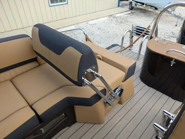 Slide: The Image of 2025 Avalon Catalina Quad Lounger 23 FT interior with tan and black seating, sleek design. - 22