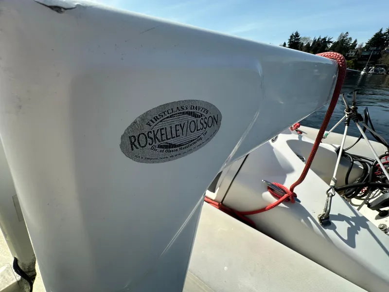 Slide: The Image of 1982 Tollycraft Tri Cabin boat detail with Roskelley/Olsson label, docked under clear sky. - 16