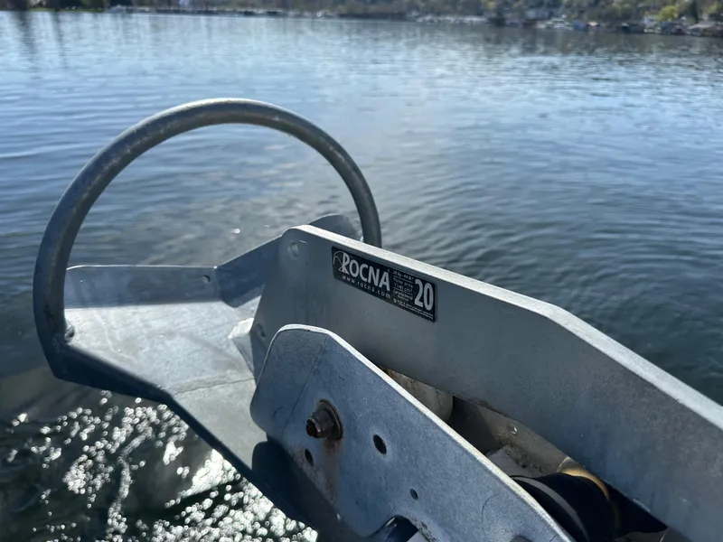 Slide: The Image of Rocna 20 anchor on 1982 Tollycraft Tri Cabin, floating on calm water. - 20