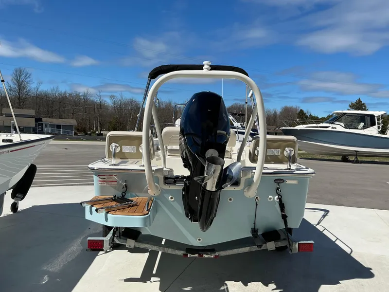 Slide: The Image of 2025 Boston Whaler 170 Montauk boat on trailer, rear view, sunny day. - 10