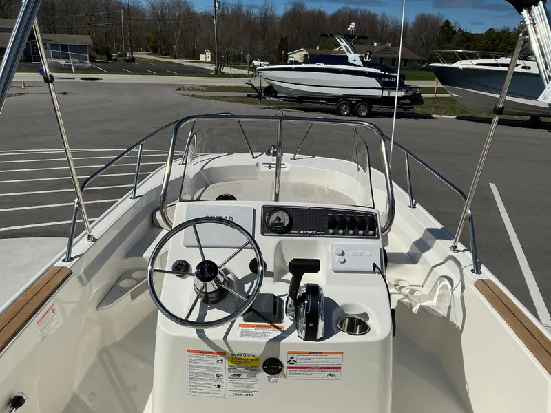Slide: The Image of 2025 Boston Whaler 170 Montauk boat interior with steering wheel and control panel. - 5