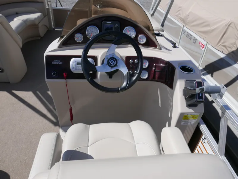 Slide: The Image of Captain's helm of 2012 Sylvan Mirage 8522 LZ pontoon boat with steering wheel and controls. - 12