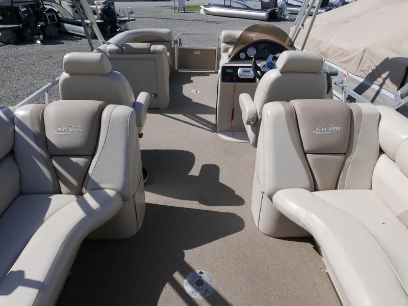 Slide: The Image of 2012 Sylvan Mirage 8522 LZ pontoon boat interior with beige seating and steering console. - 14