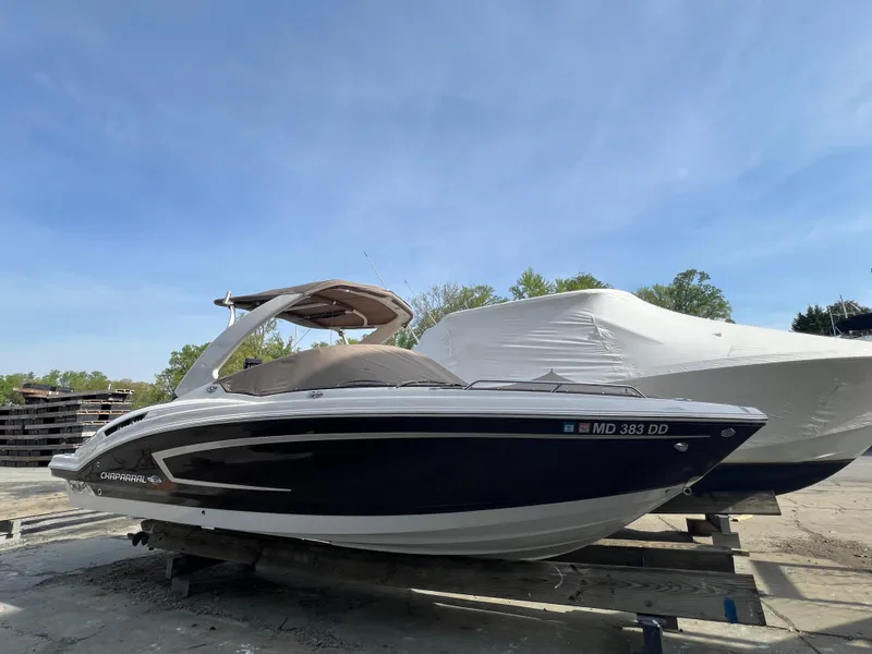 Slide: The Image of 2014 Chaparral 257 SSX boat on a trailer under clear blue sky. - 0
