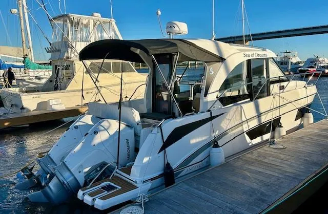 Slide: The Image of 2024 Beneteau Antares 9 docked, featuring sleek design and twin outboard engines. - 1