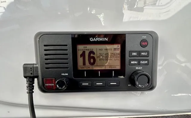 Slide: The Image of Garmin marine radio on 2024 Beneteau Antares 9, displaying channel 16 distress signal. - 21